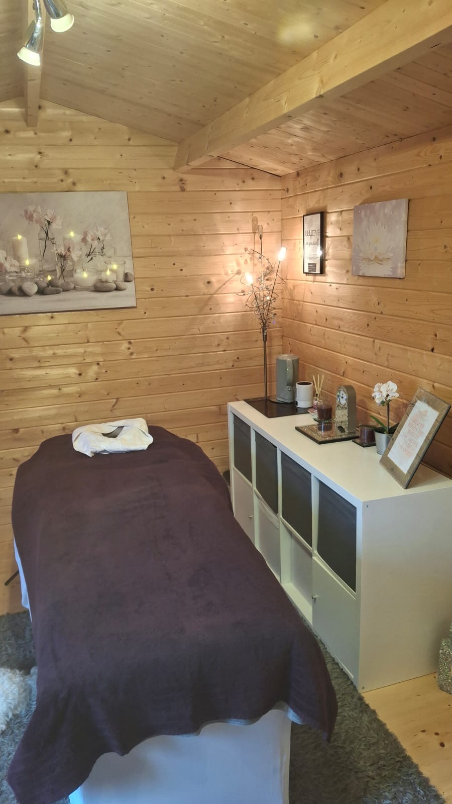 Massage bed and cosy interior of the beauty cabin